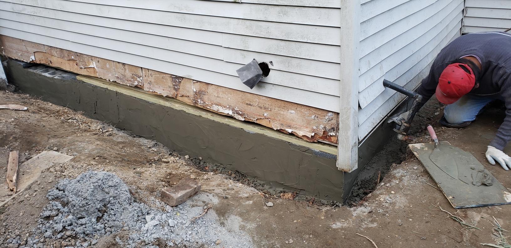 Professional foundation repair specialists working on crack repair in Lexington, Kentucky basement